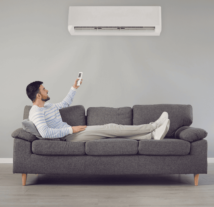 Homme profitant du confort d’une climatisation réversible installée à Pau par Héméra Énergies